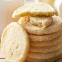 Stacks of slice and bake sable cookies with cups of tea.