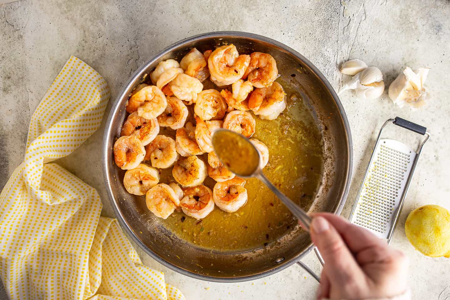 Shrimp scampi simmering in a buttery lemon garlic sauce.