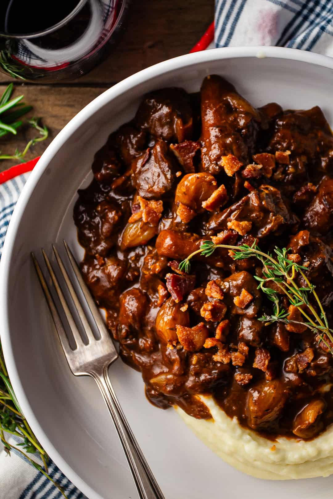 Beef bourguignon recipe, prepared and ladled over mashed potatoes.