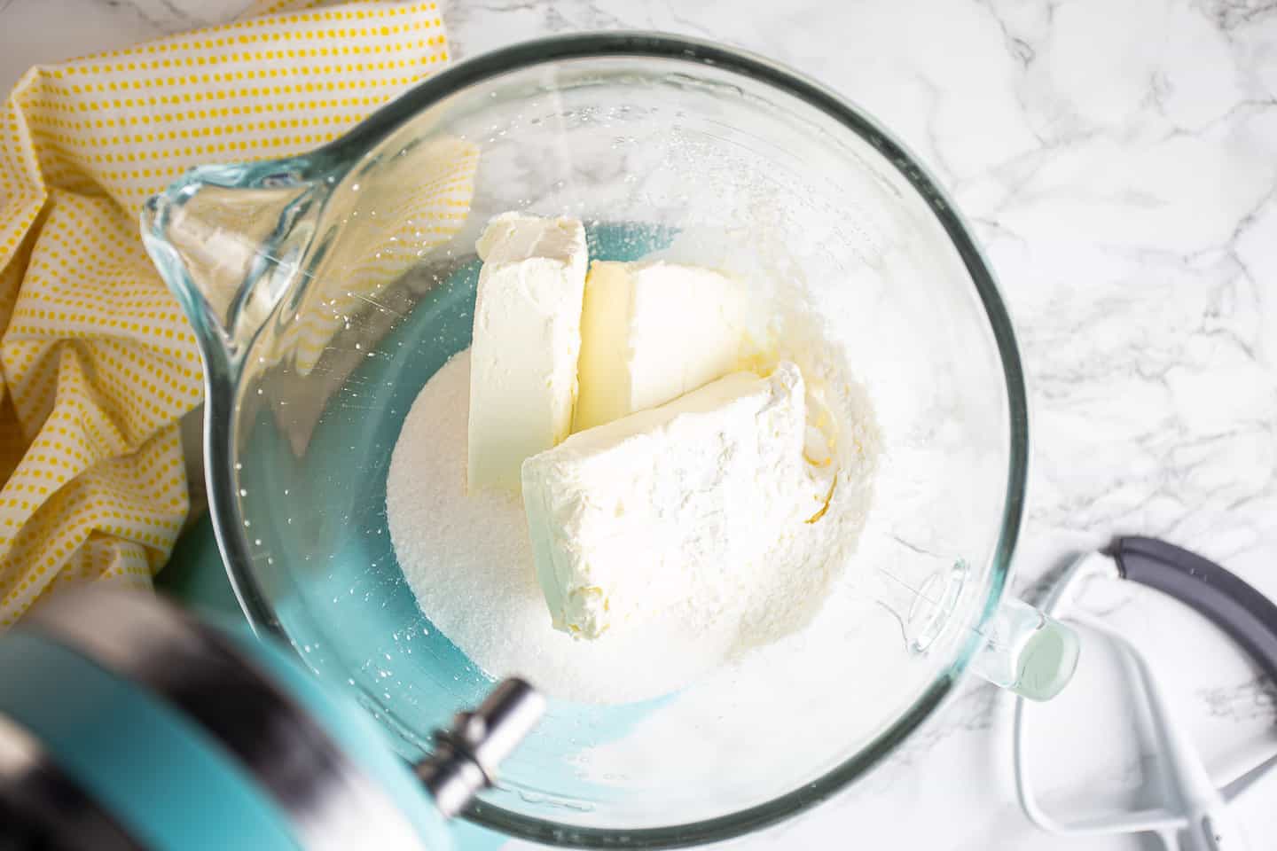 Cream cheese, sugar, cornstarch and cream in the bowl of a stand mixer.