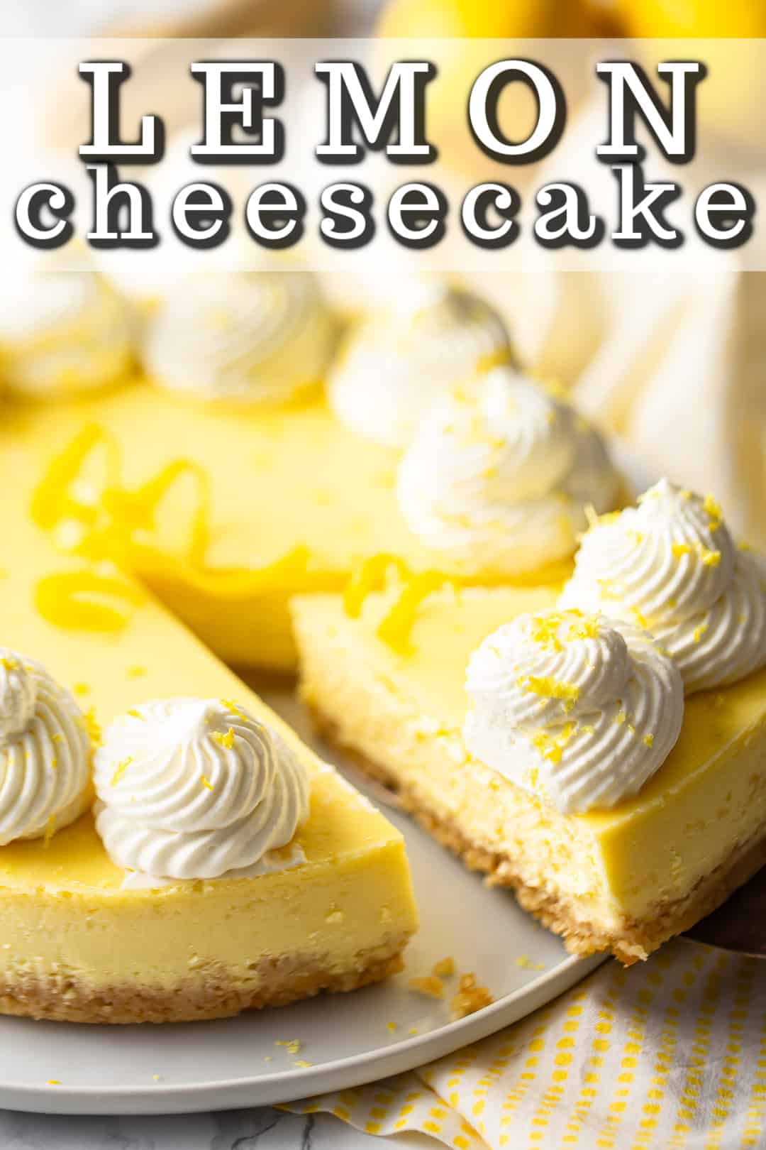 Lemon cheesecake recipe, baked and topped with whipped cream and citrus zest.