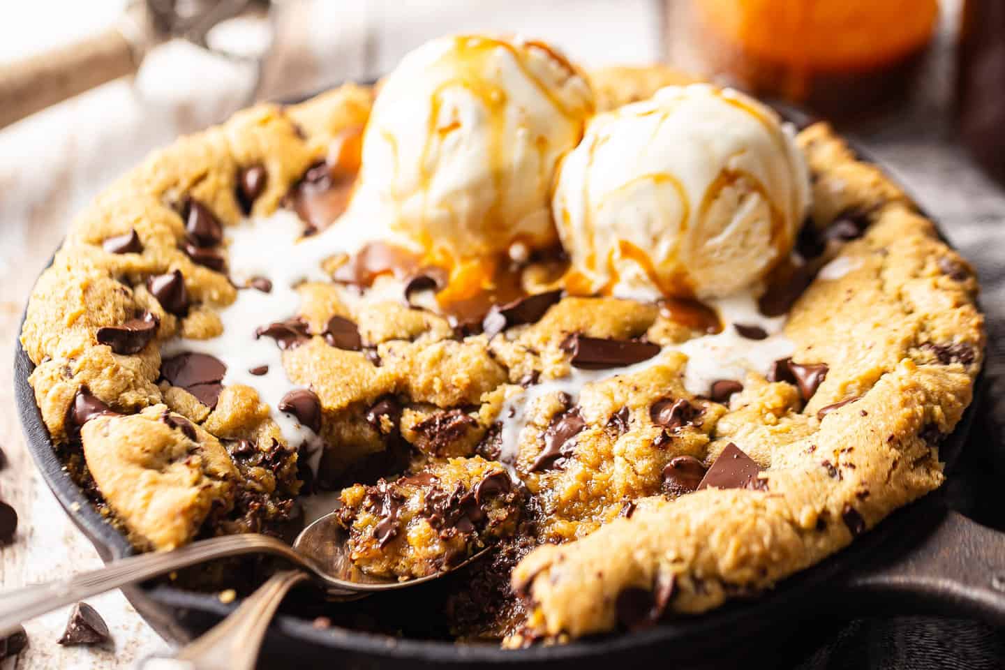 Cast iron skillet cookie with chocolate chips, ice cream, and caramel sauce.