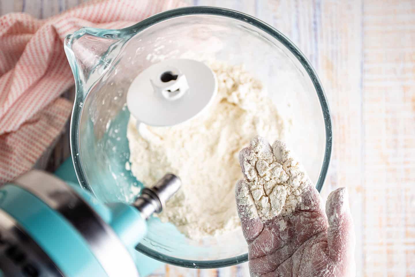 Blending dry ingredients with butter until it resembles coarse crumbs.