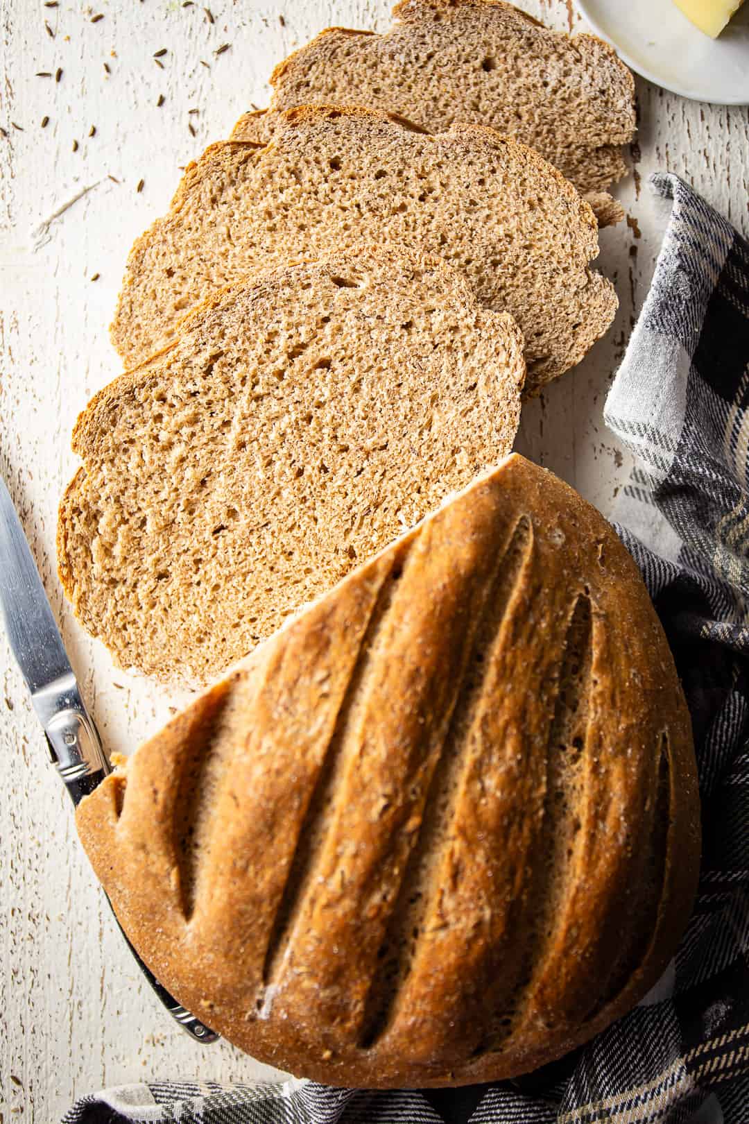 Bread with rye baked into a loaf and sliced for sandwiches or toast.