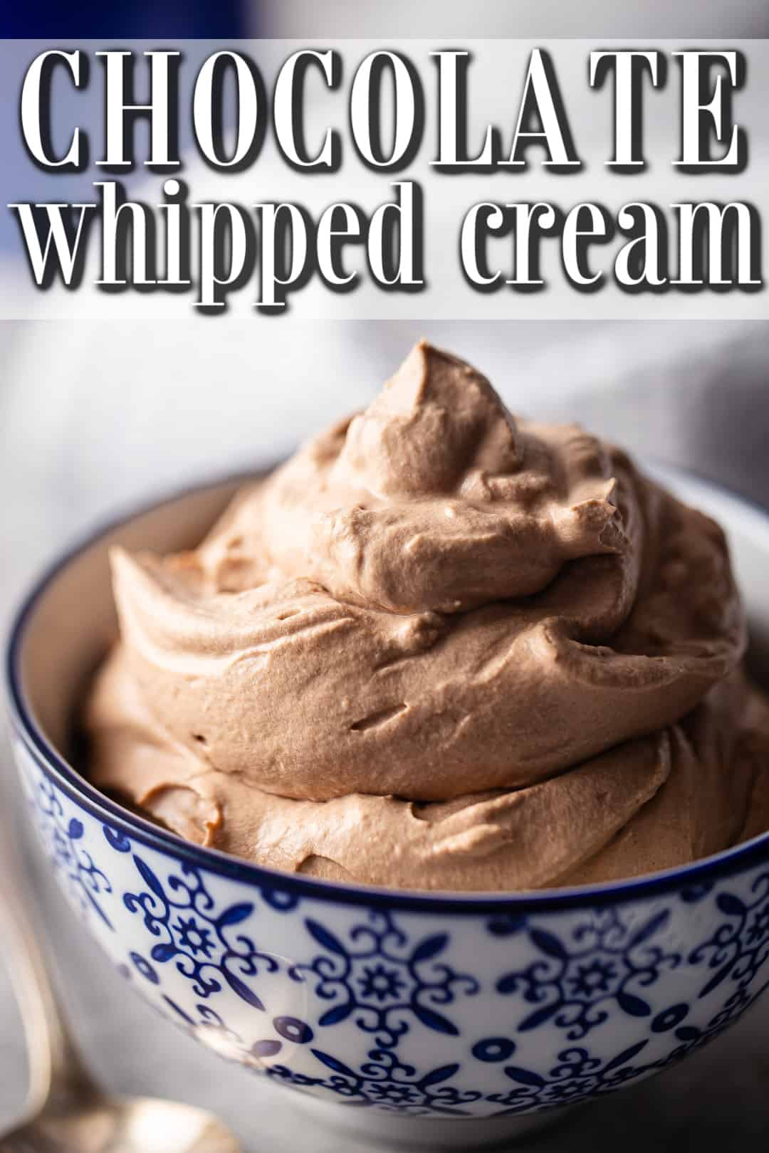 Chocolate whipped cream frosting piled into a blue and white bowl, with a text banner above.