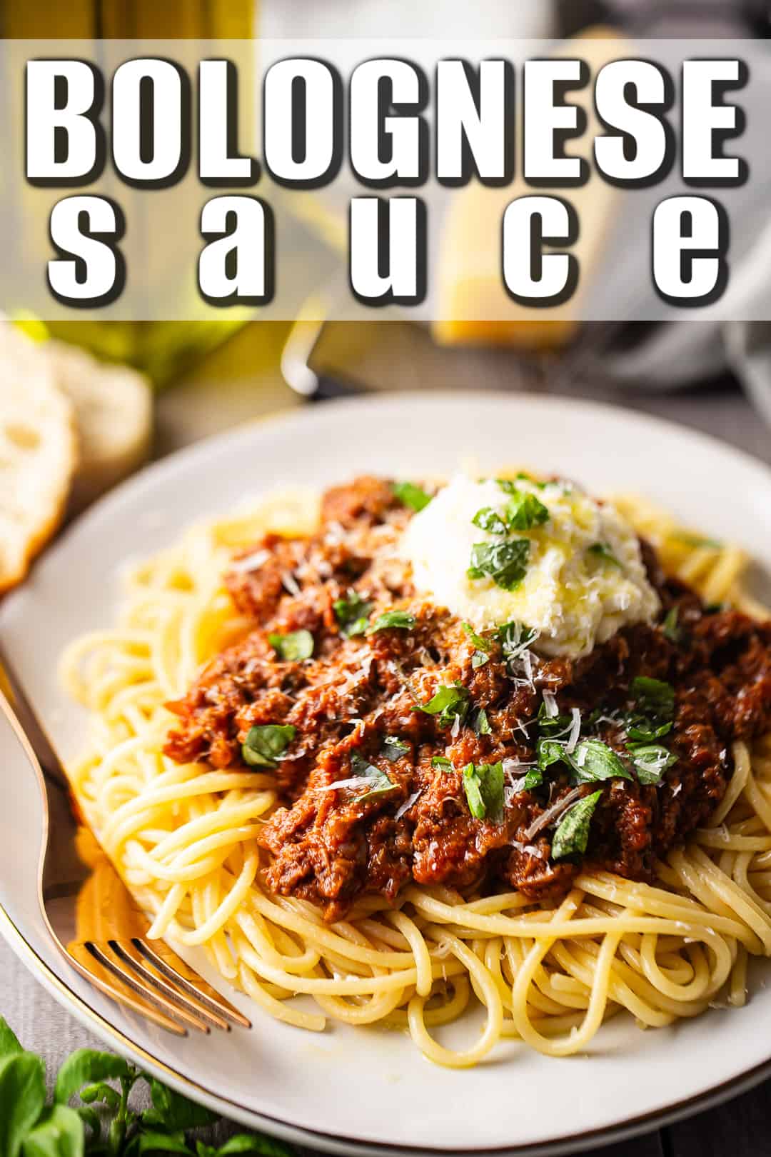 Bolognese recipe, prepared and served over pasta with fresh basil.
