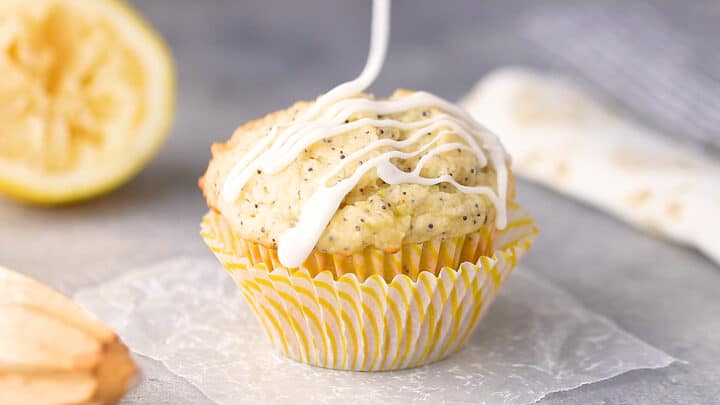 Drizzling a lemon poppy seed muffin with lemon glaze.