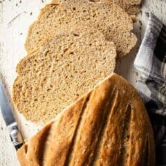Bread with rye baked into a loaf and sliced for sandwiches or toast.