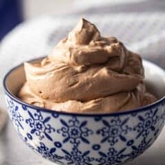 Chocolate whipped cream piled into a blue and white bowl.