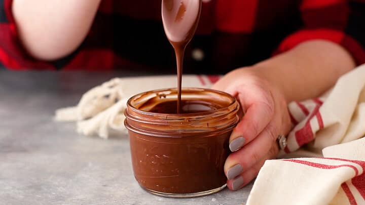 Stirring melted chocolate until it's completely smooth and melted.