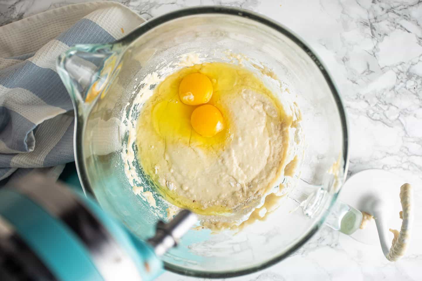 Adding eggs to babka dough.