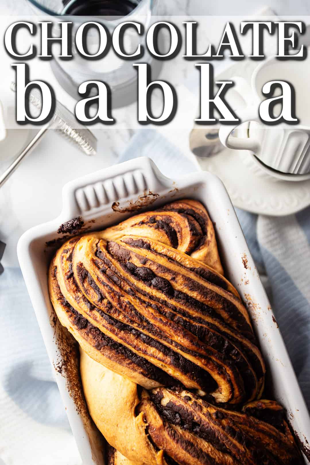 Chocolate babka recipe, baked in a white stoneware loaf pan.