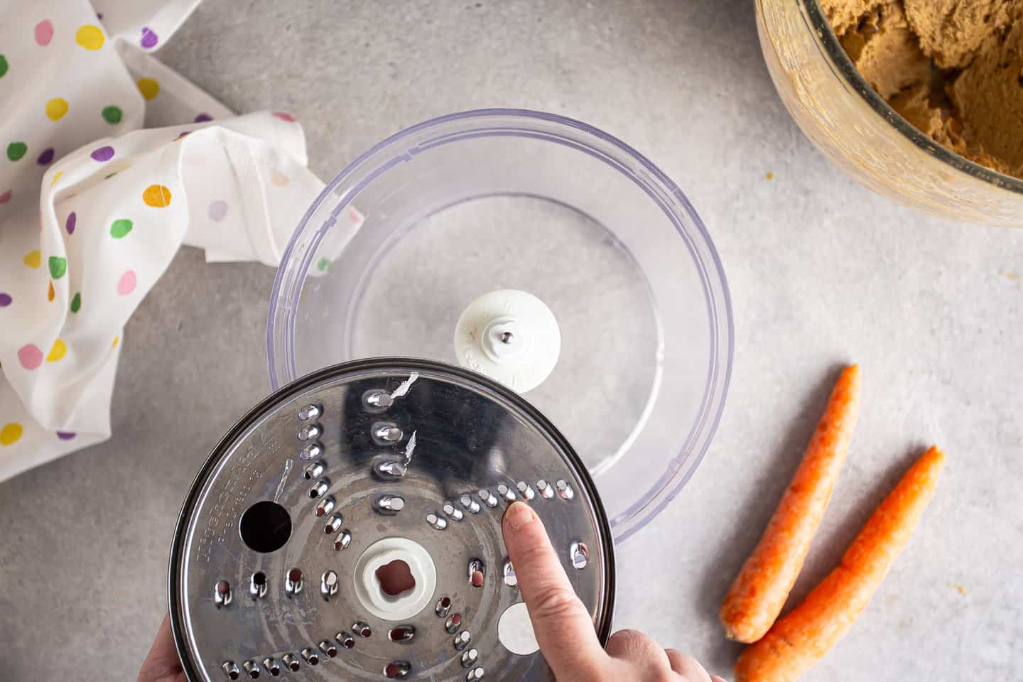 Preparing to grate carrots with a fine food processor blade.