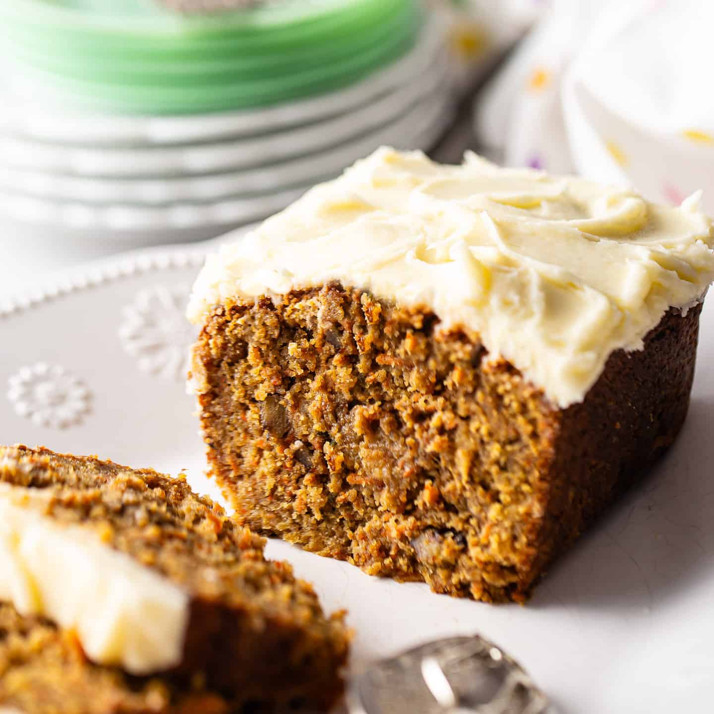 Carrot cake loaf with a thick blanket of cream cheese frosting.