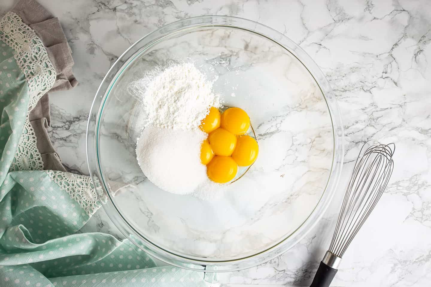Egg yolks, sugar, cornstarch, and salt in a large glass mixing bowl.