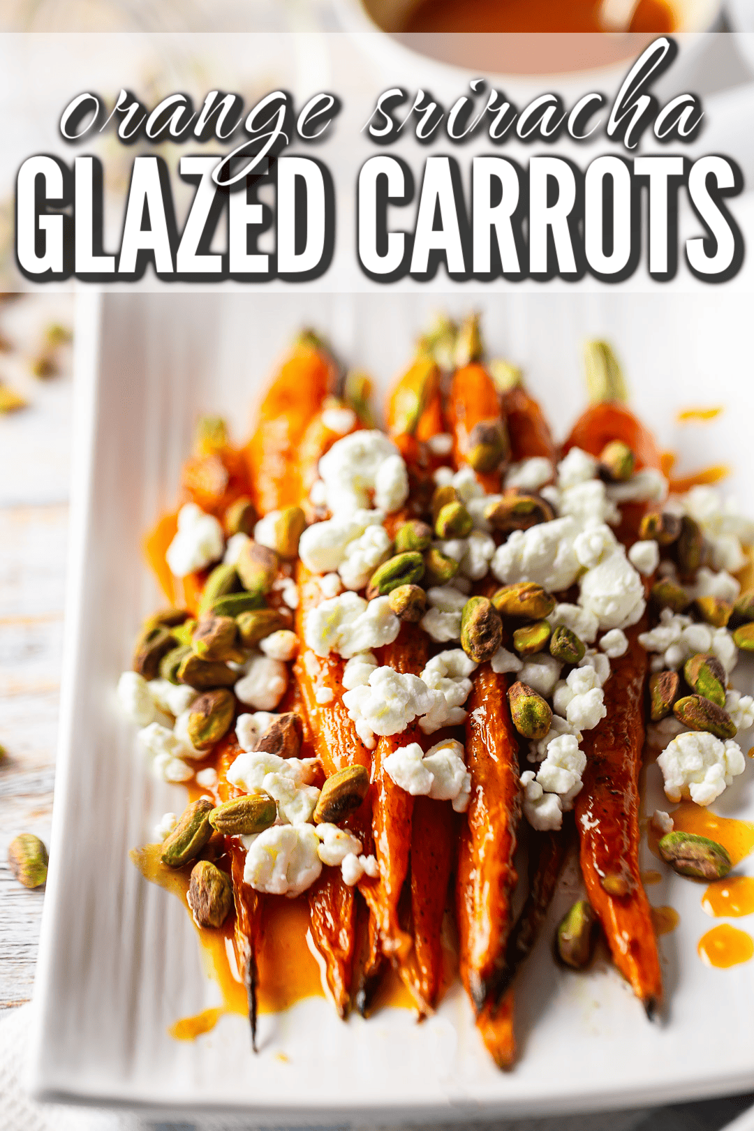 Glazed carrots recipe prepared and garnished with goat cheese and toasted pistachios.