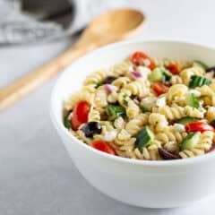 Close up of Greek pasta salad in a bowl.