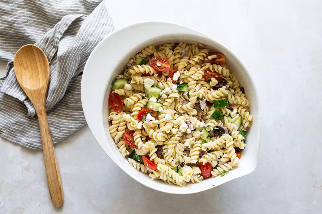 Pasta salad Greek mixed together in a bowl.