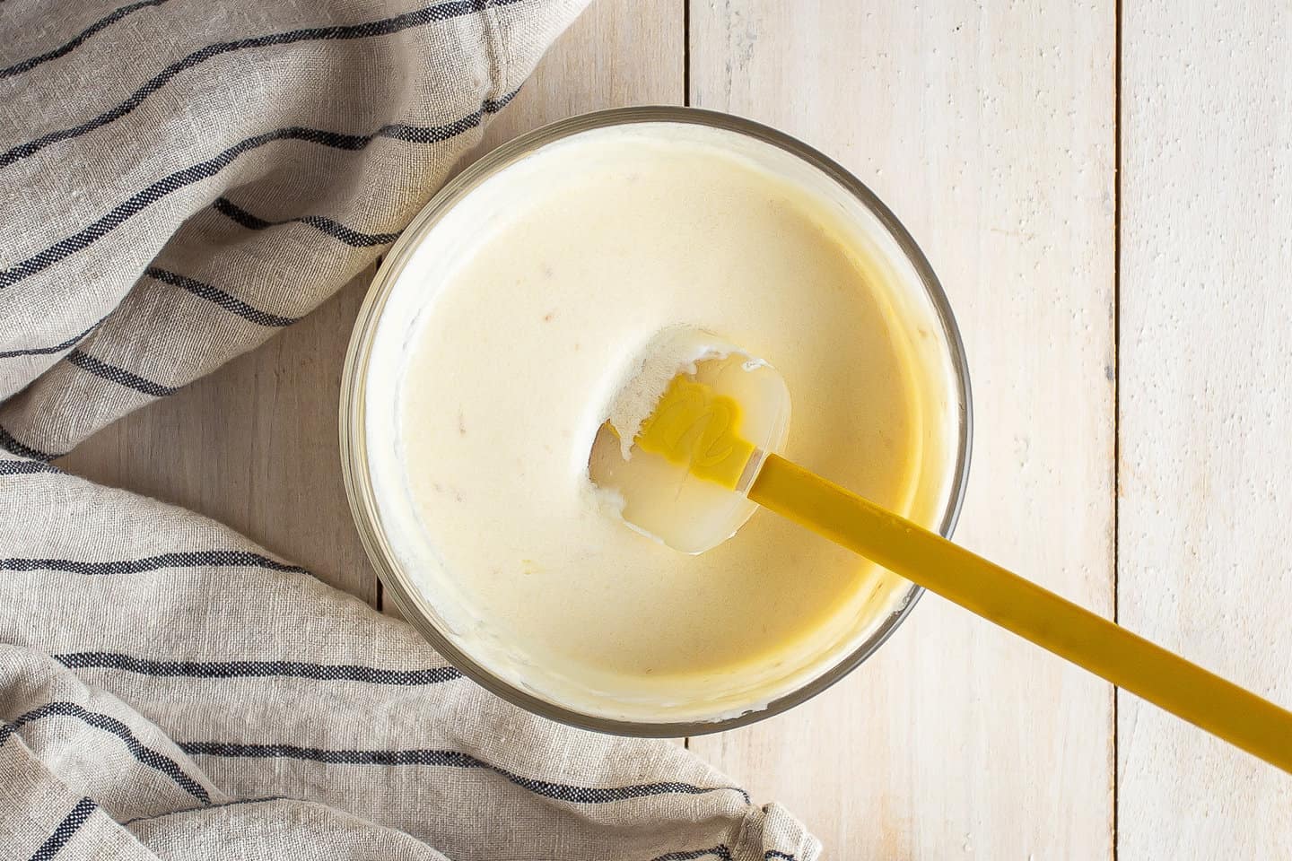 Melted butter, sour cream, milk, and vanilla extract stirred together in a small bowl.
