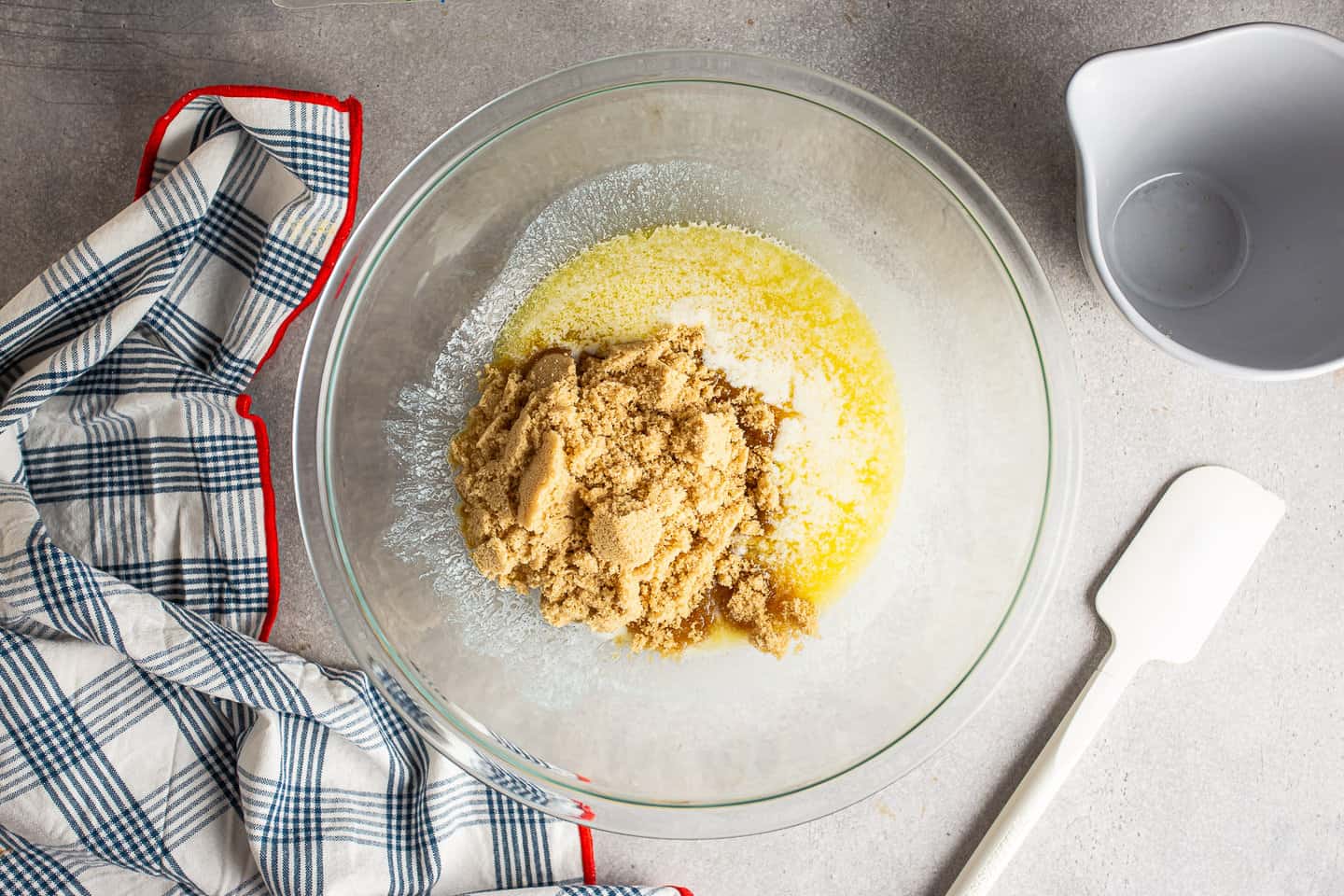 Melted butter and brown sugar in a large glass mixing bowl.