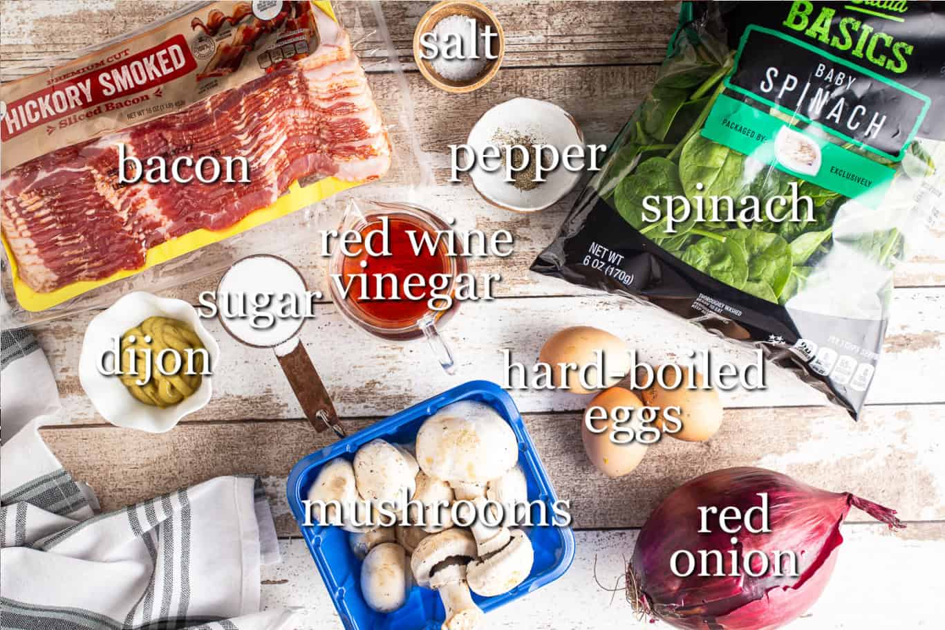 Ingredients for making spinach salad with warm bacon dressing, with text labels.