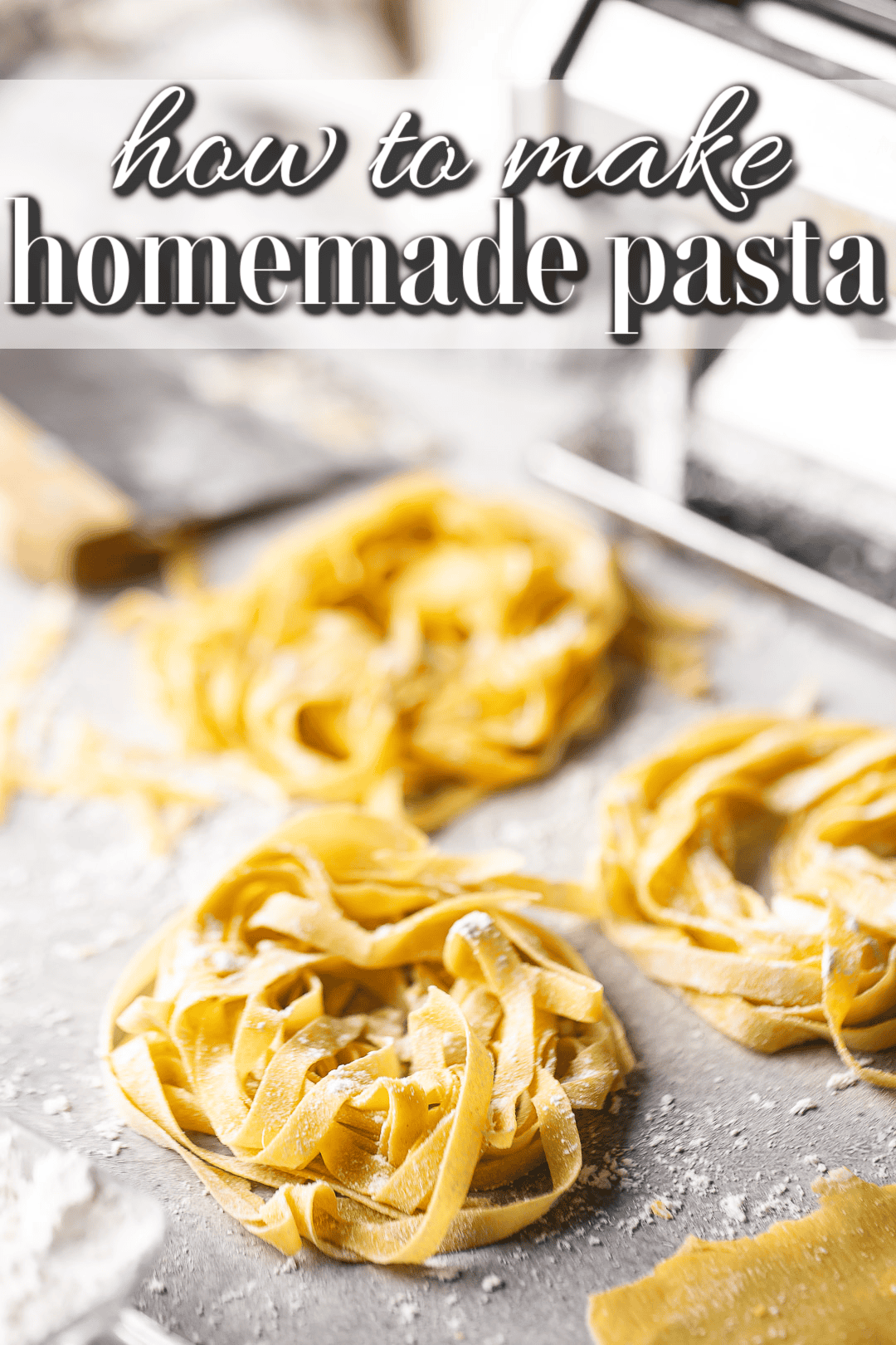 Homemade pasta dusted with flour and presented on a pale gray surface.