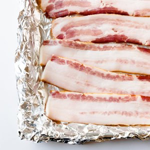 bacon slices on a foil lined baking sheet.