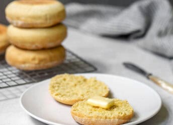 English muffins on a plate with butter.