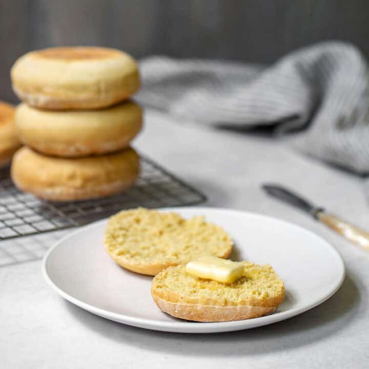 English muffins on a plate with butter.