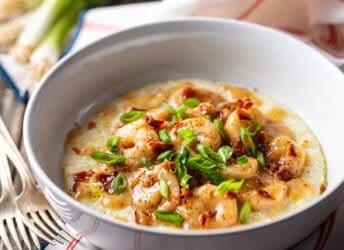 Shrimp and grits in a wide ceramic bowl.