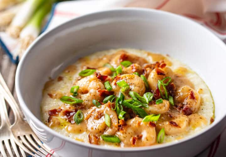 Shrimp and grits in a wide ceramic bowl.