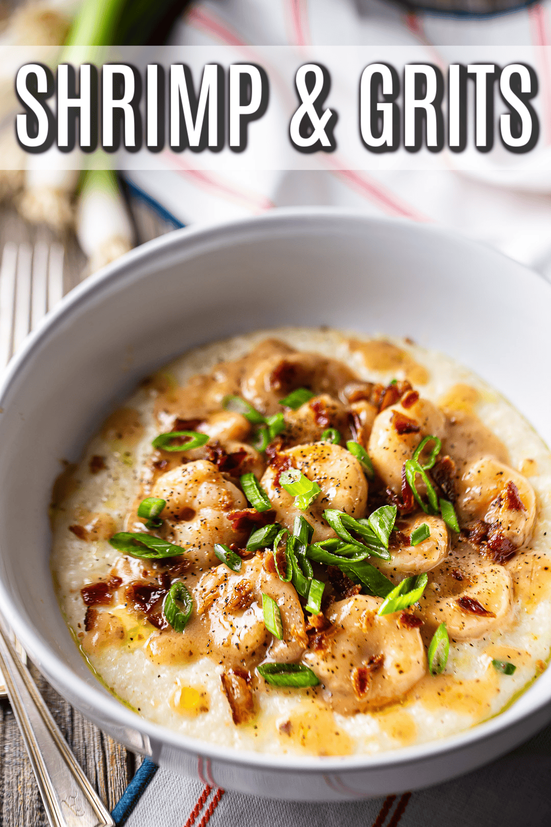 Shrimp and grits recipe, prepared and garnished with bacon and scallions.