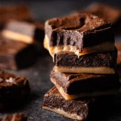 Salted caramel brownies stacked on top of one another.