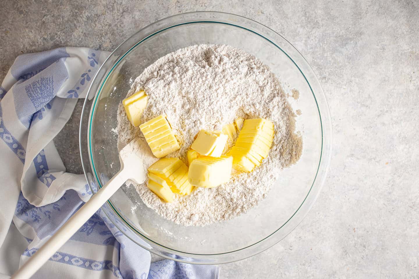 Adding butter to dry ingredients.