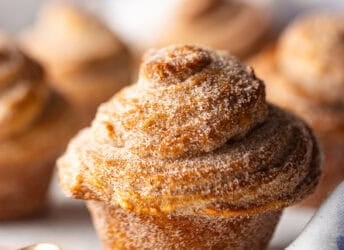 A cruffin pastry with cinnamon sugar coating.