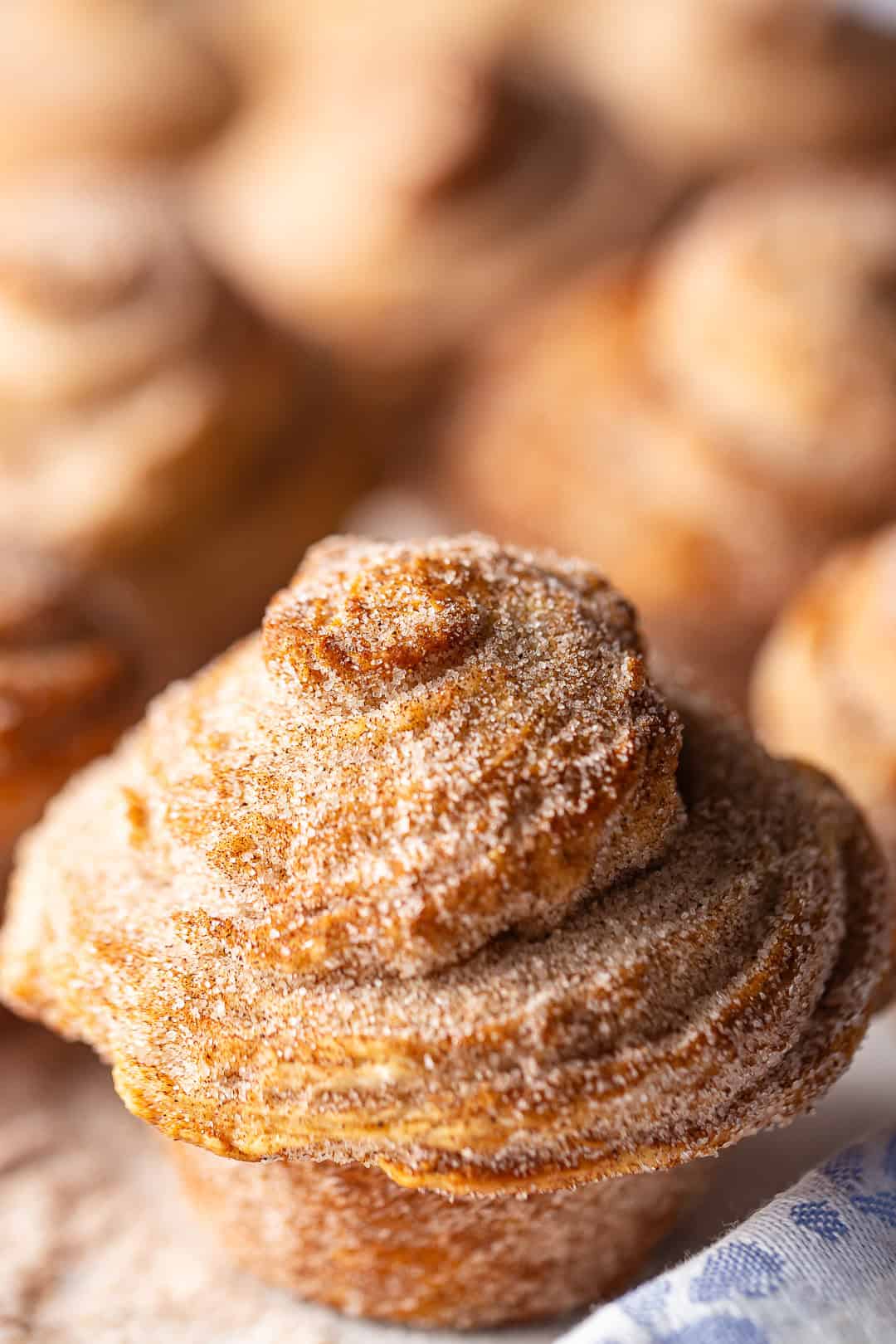 Cruffin recipe baked and coated in cinnamon sugar.