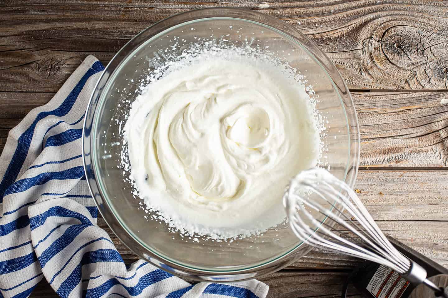 Whipping cream with a handheld electric mixer.