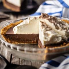 Chocolate pudding pie with a slice removed to highlight the creamy interior.