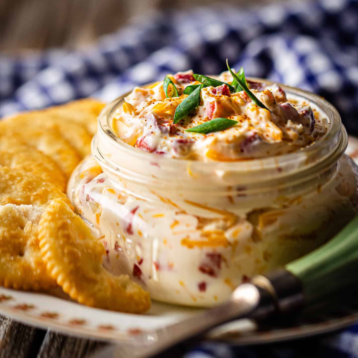 Pimento cheese served in a canning jar with buttery crackers.