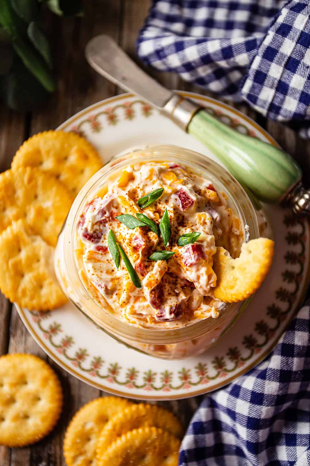 Homemade pimento cheese garnished with cayenne and scallions.