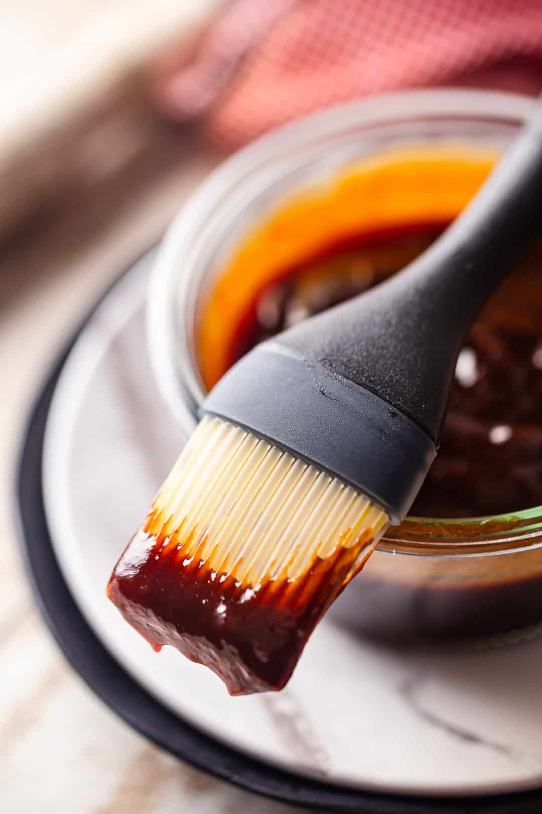 Homemade barbecue sauce clinging to a silicone brush.