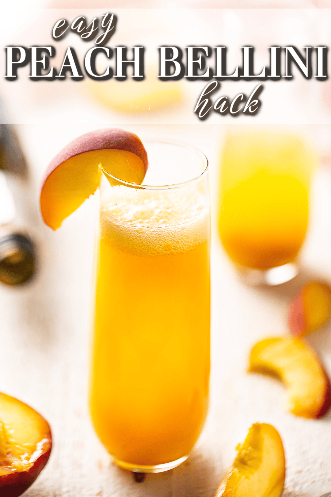 Peach Bellini surrounded by fresh peaches.