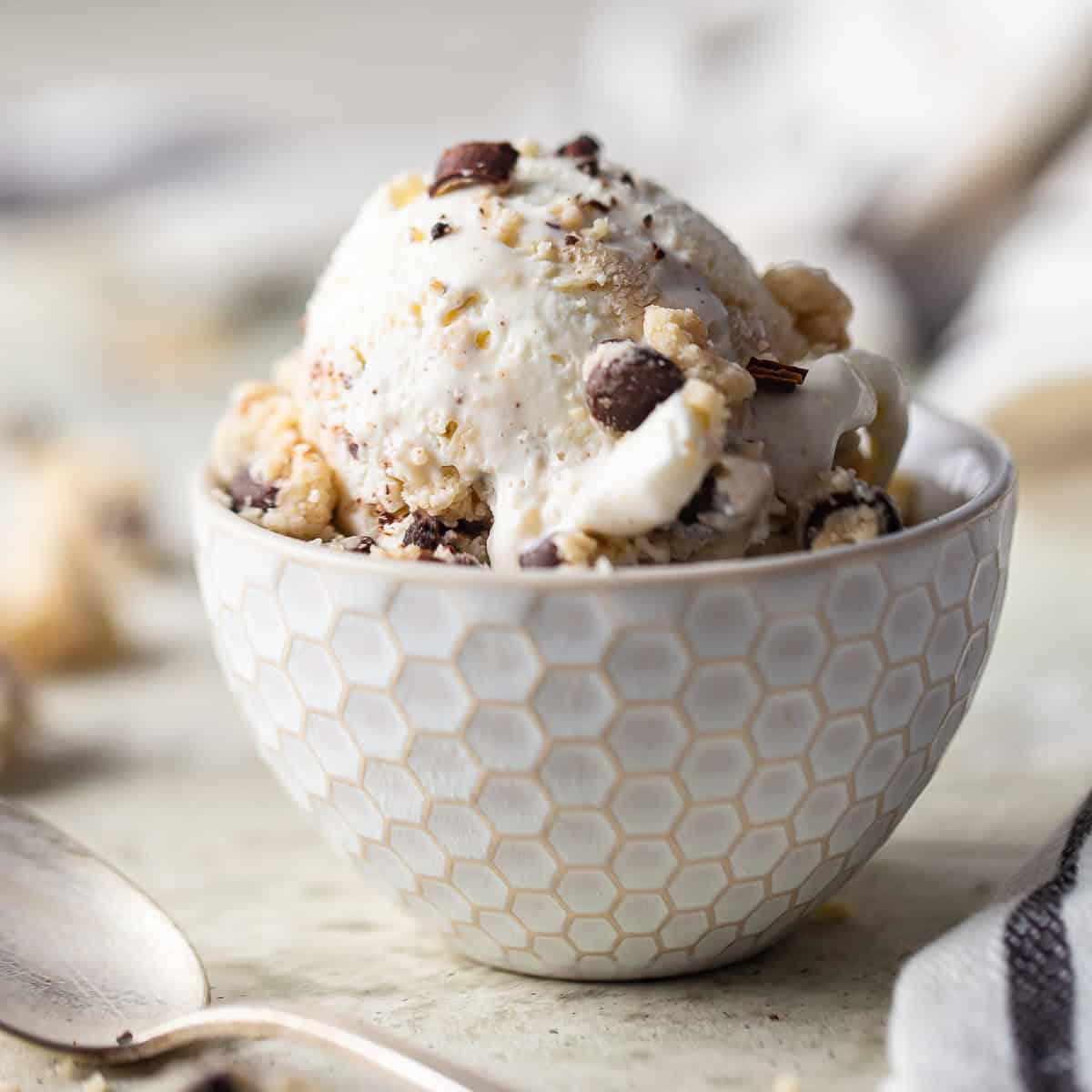 Homemade cookie dough ice cream scooped into a white ceramic bowl.