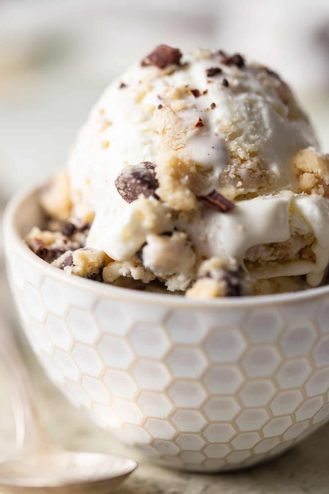 Cookie dough ice cream recipe, prepared and served in a small bowl with a vintage silver spoon.