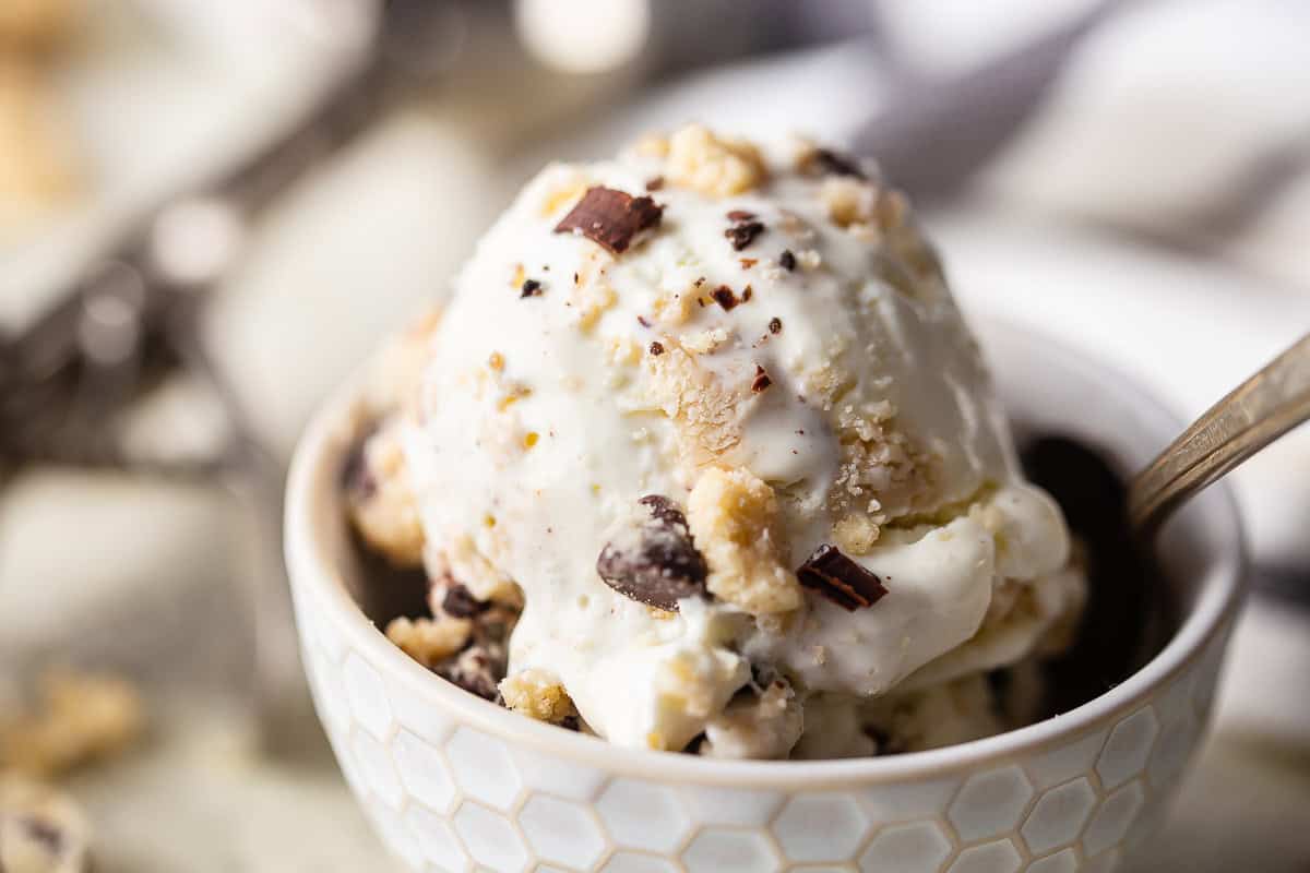 Best cookie dough ice cream recipe made and scooped into a bowl with a vintage ice cream scoop in the background.