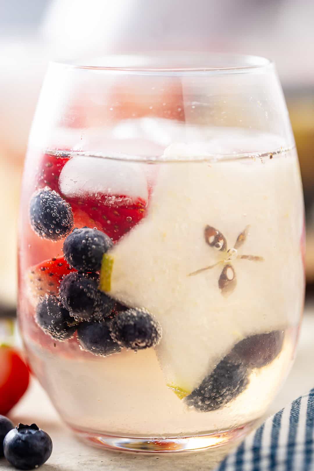 White wine sangria with berries and star-shaped pear slices.