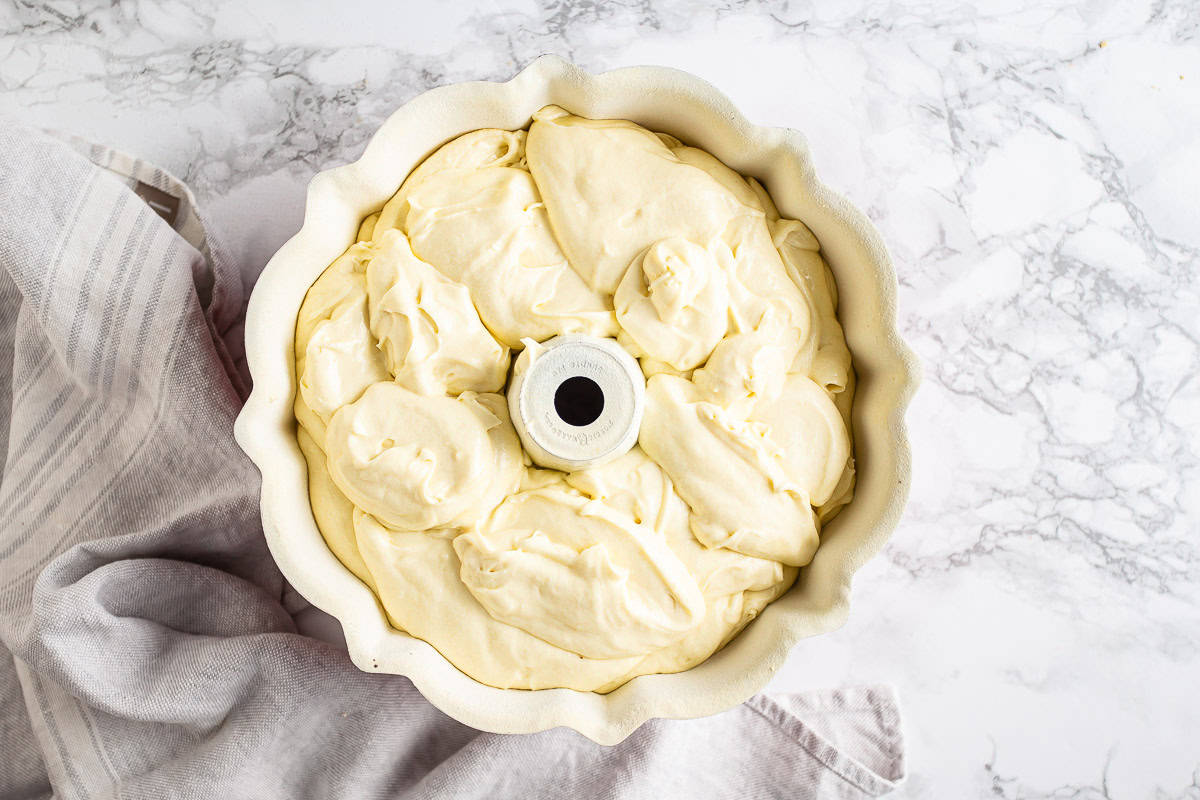 Unbaked cream cheese pound cake in a bundt pan.
