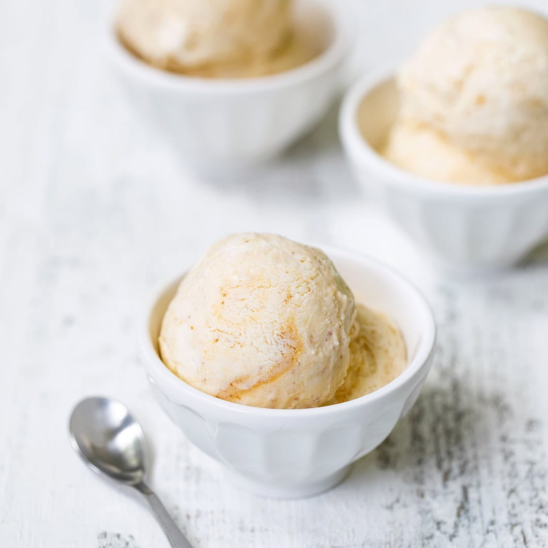 Peach ice cream in three bowls