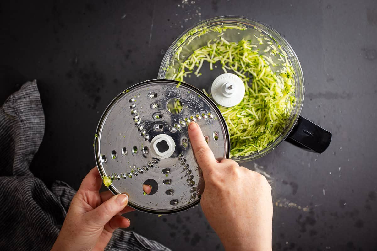 Pointing out the finer cutting blade on a food processor's grating disc.