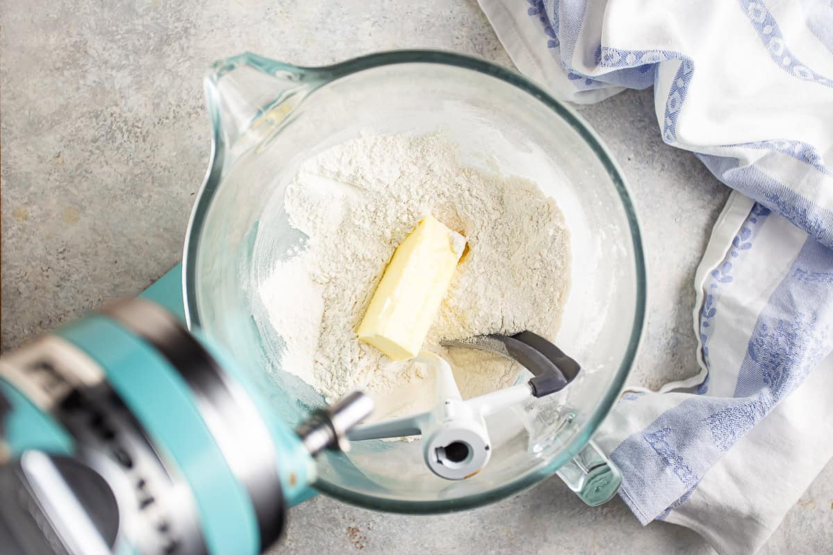 Adding softened butter to dry ingredients.